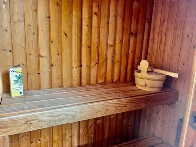 a wooden sauna with a wooden toilet in it at Olive Sense Villa with jacuzzi and sauna in Afantou