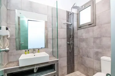 a bathroom with a sink and a shower at Hillside Studios & Apartments in Faliraki