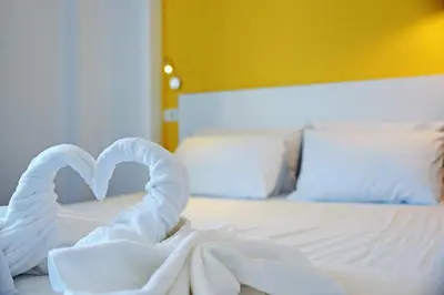 a bed with two swans made out of towels at Hillside Studios & Apartments in Faliraki