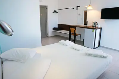 a hotel room with a bed and a desk at Hillside Studios & Apartments in Faliraki
