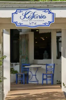 a sign for a table and chairs on a patio at Esperos Mare Resort & Spa in Faliraki