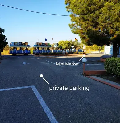 a street with two buses parked in a parking lot at Kyriakos Studios in Afantou