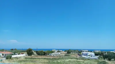 a view of a town with the ocean in the background at Kyriakos Studios in Afantou