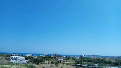 a view of a city with a blue sky at Kyriakos Studios in Afantou