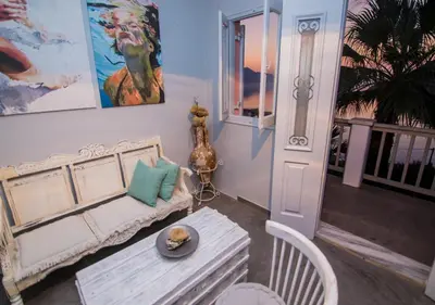 a living room with a couch and a table at Niriides Hotel Apartments in Symi