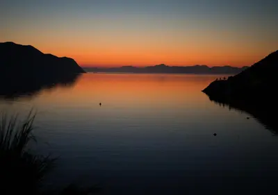 a sunset over a large body of water at Niriides Hotel Apartments in Symi