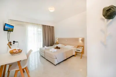 a hotel room with a bed and a table at Sokrates Studios in Afantou