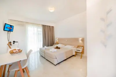 a hotel room with a bed and a table at Sokrates Studios in Afantou