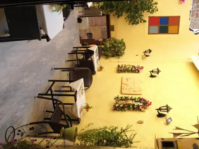 an overhead view of a patio with tables and flowers at Olympos Pension in Rhodes Town