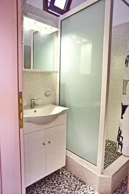 a bathroom with a sink and a glass shower at Olympos Pension in Rhodes Town