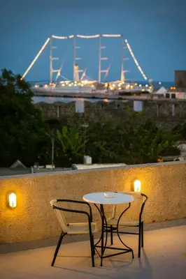 a table and chairs with a view of a bridge at Camelot Traditional & Classic Hotel in Rhodes Town