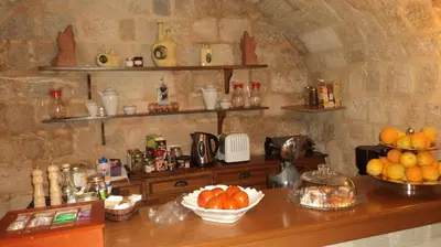 a counter with bowls of fruit on top of it at Camelot Traditional & Classic Hotel in Rhodes Town