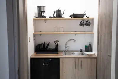 a small kitchen with a sink and a shelf at Star Hotel in Rhodes Town