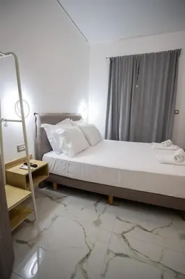 a bedroom with a bed with a mirror and a window at Star Hotel in Rhodes Town