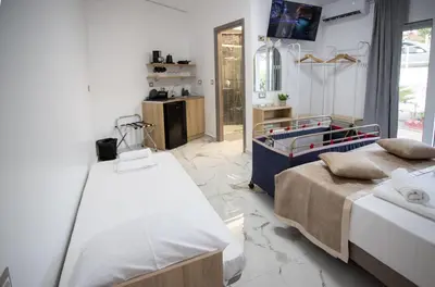 a bedroom with two beds and a table at Star Hotel in Rhodes Town