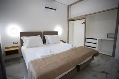 a bedroom with a large bed with white sheets at Star Hotel in Rhodes Town