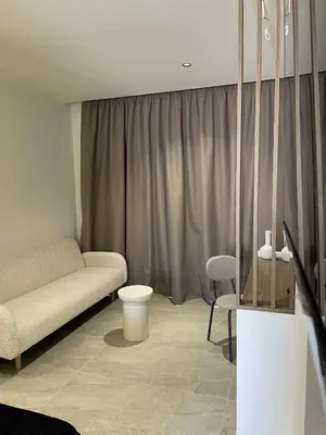 a living room with a couch and a chair at Kostas Studios in Faliraki