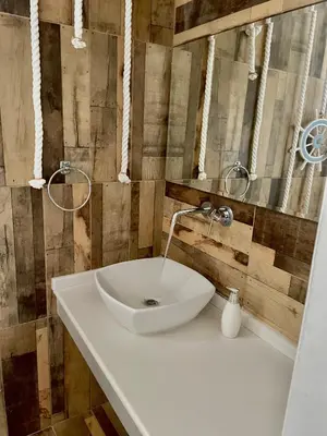 a bathroom with a white sink and a mirror at Kostas Studios in Faliraki
