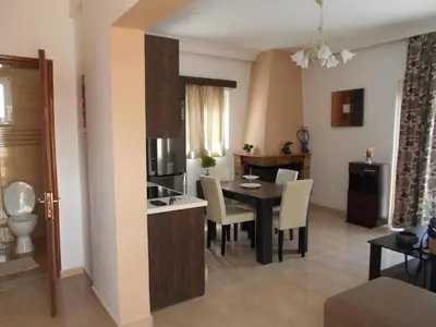 a kitchen and dining room with a table and chairs at Village House in Kalithies