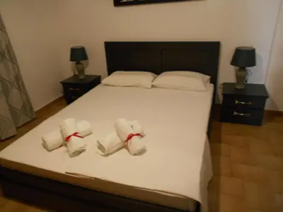 a bedroom with a bed with two towels on it at Village House in Kalithies