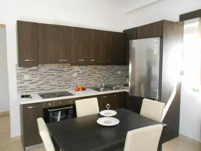 a kitchen with a black table with white plates on it at Village House in Kalithies