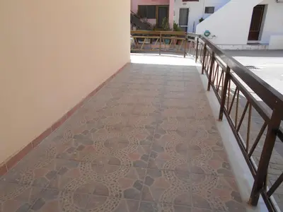 a walkway with a tile floor and a railing at Village House in Kalithies