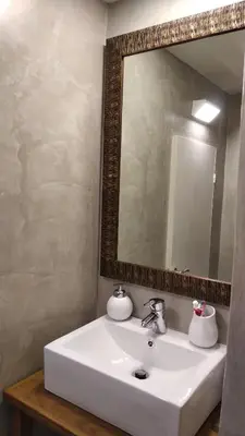 a bathroom with a white sink and a mirror at Yalitzi in Symi
