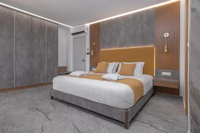 a bedroom with a large bed in a room at Rhodos Horizon Boutique-Adults only in Rhodes Town