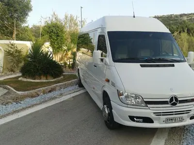 a white van parked on the side of a street at Iatridis Studios Faliraki in Faliraki