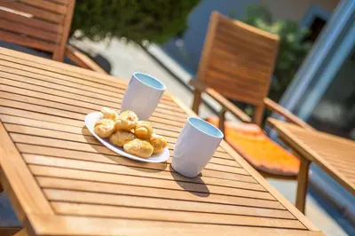a plate of food and two cups on a table at Iatridis Studios Faliraki in Faliraki
