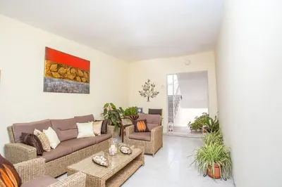 a living room with a couch and a table at Iatridis Studios Faliraki in Faliraki