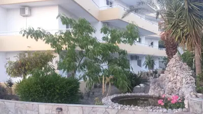 a building with a fountain in front of it at Summer Days in Faliraki