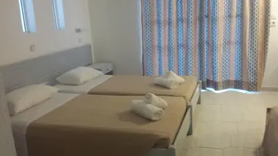 two beds in a hotel room with towels on them at Summer Days in Faliraki