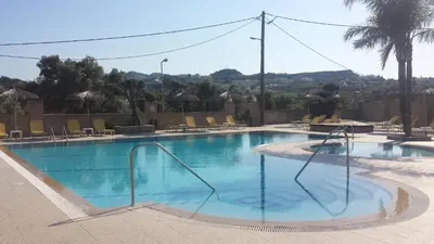 a swimming pool with a slide in the middle at Summer Days in Faliraki