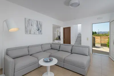 a living room with a couch and a table at Olive Tree House in Gennadi