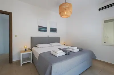 a bedroom with a bed with towels on it at Olive Tree House in Gennadi