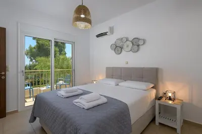 a bedroom with a bed with two towels on it at Olive Tree House in Gennadi