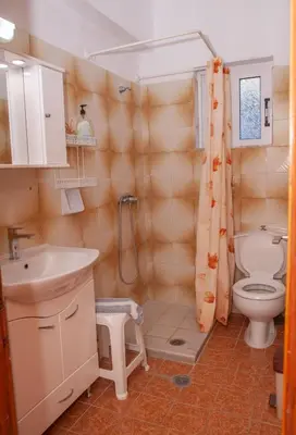 a bathroom with a toilet and a sink at Villa Stamatis in Pefki Rhodes