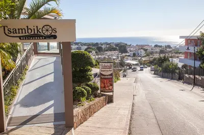 a sign for a restaurant on the side of a street at Villa Stamatis in Pefki Rhodes