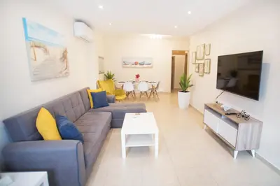 a living room with a couch and a table at Rhodes Marine House in Rhodes Town