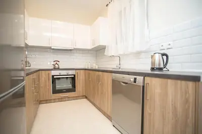a kitchen with wooden cabinets and stainless steel appliances at Rhodes Marine House in Rhodes Town