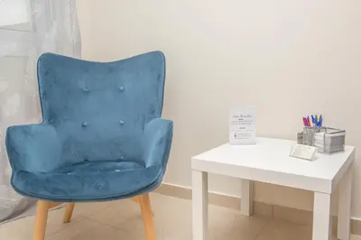 a blue chair sitting next to a white table at Rhodes Marine House in Rhodes Town