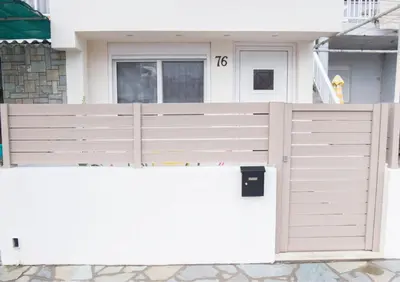 a white fence in front of a house at Rhodes Marine House in Rhodes Town