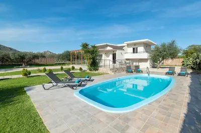 a swimming pool in the backyard of a house at Sugar View Villa In Kolymbia in Kolimbia