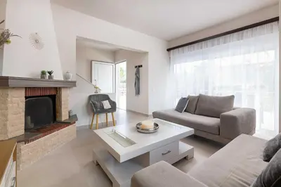a living room with a couch and a fireplace at Sugar View Villa In Kolymbia in Kolimbia