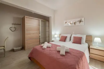 a bedroom with a large bed with towels on it at Sugar View Villa In Kolymbia in Kolimbia