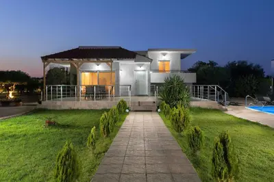 a house with a pathway in front of a yard at Sugar View Villa In Kolymbia in Kolimbia