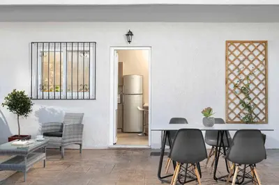 a kitchen and dining room with a table and chairs at Sugar View Villa In Kolymbia in Kolimbia