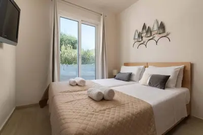 a bedroom with two beds with towels on them at Sugar View Villa In Kolymbia in Kolimbia