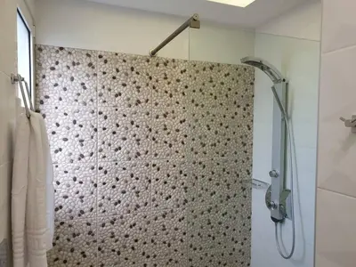 a bathroom with a shower with a shower curtain at Sea Breeze Villa in Haraki